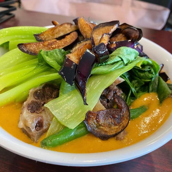 Filipino Kare-Kare with oxtail, green beans, bok choy, and eggplant in a peanut sauce.
