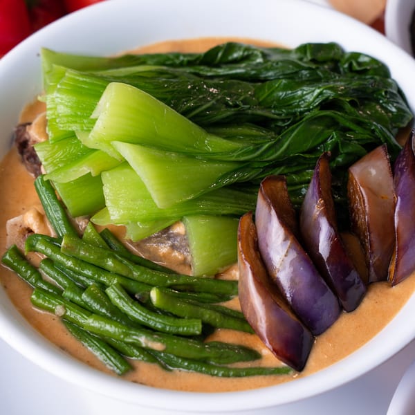 Filipino Kare-Kare with bok choy, green beans, and eggplant in a rich peanut sauce.